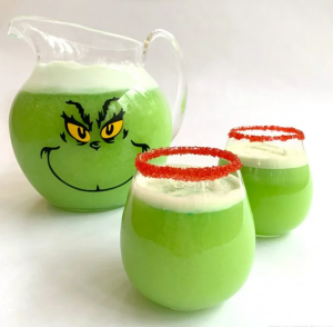 Grinch Punch in pitcher with cups